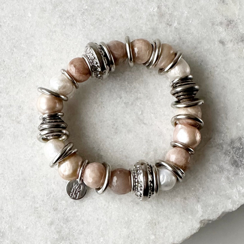 
                      
                        Lustrous Baroque Freshwater Pearls, Large Semi-Precious Stones, Metal Beads and Silver Bands make up this Stretch Bracelet (approx. 7”) in Three Different Colour Combinations. Peach and Taupe are Highlighted
                      
                    
