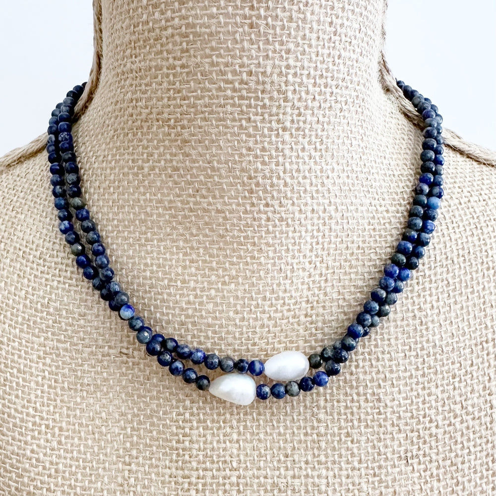 
                      
                        Necklace with blue beads on a mannequin bust
                      
                    