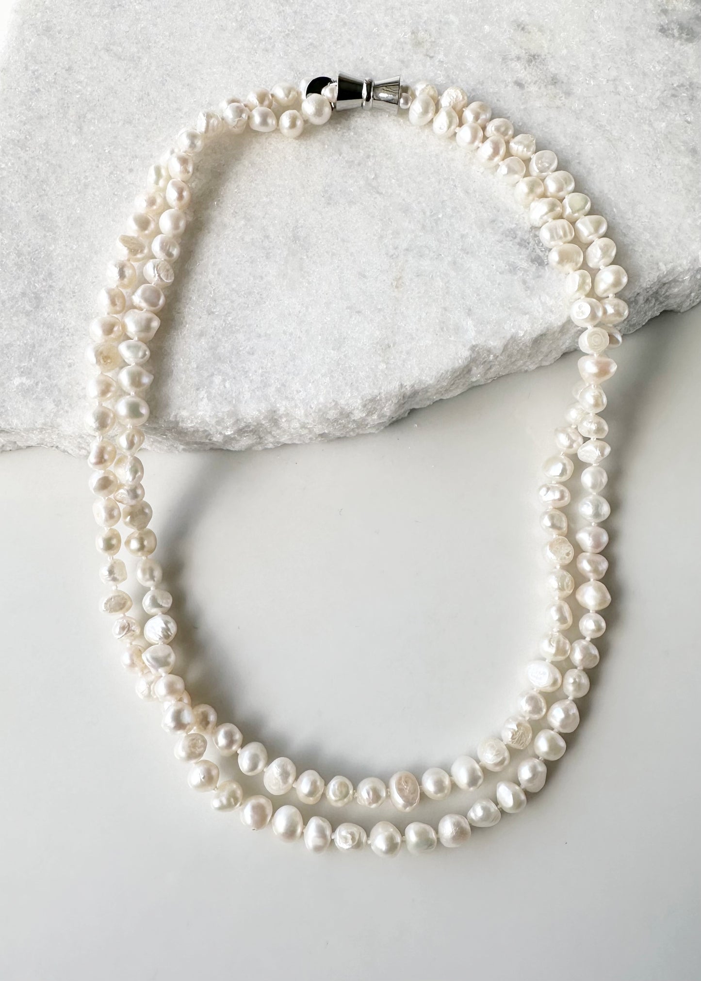 White Freshwater Baroque 8-9mm Knotted Pearls Form a 20” Lustrous Necklace with a Strong Secure Magnetic Clasp for Easy Wear.