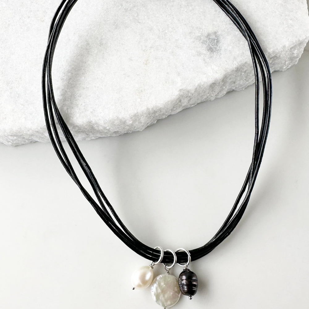 This 18.5” Necklace Features Three Beautiful Freshwater Pearls on Leather Cord to bring a subtle, elegant touch, Finished with a Magnetic Clasp for Easy Wear. Designed and Made in Canada
