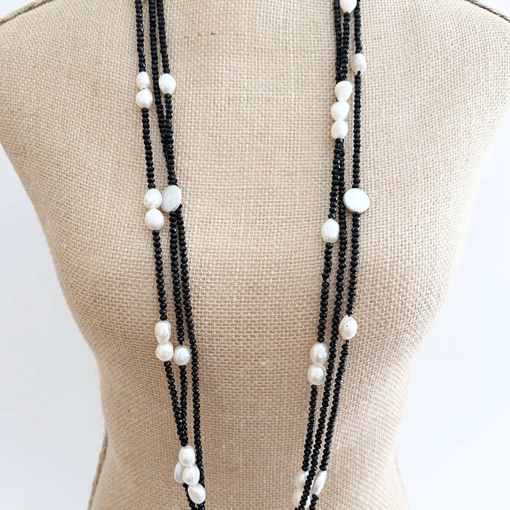 
                      
                        Long (40”) Black Crystal Necklace with Coin and Rice-Shaped Pearls Set with a Strong Secure Magnetic Clasp for Easy wear. Can be worn As Is or Doubled. On Bust
                      
                    