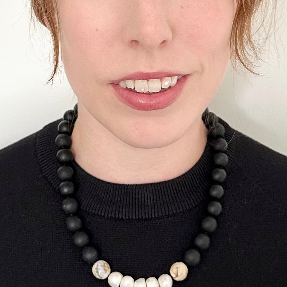 
                      
                        This 21” Necklace Showcases Five Radiant Pearls Accented by Faceted 14mm Beige Agate and Matte Black Agate Stones. It Fastens Effortlessly with a Convenient Magnetic Clasp, Combining Style and Ease. Designed in Canada
                      
                    
