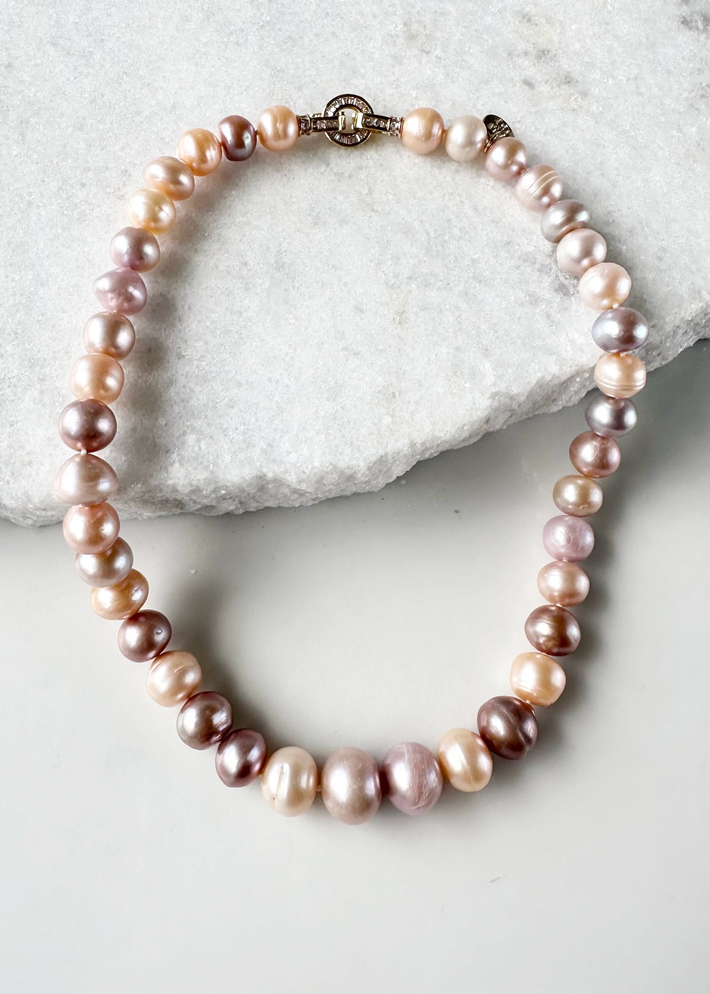 Designed in Canada, these Graduated, Jumbo-Sized, and Lustrous Freshwater Pearls combine for a Beautiful 18” Necklace that has Impact.  Freshwater Pearls ranging from 11mm to 14mm are Completed with a Pretty Cubic Zirconia Set Clasp. These strands are Beautiful in both White and Pink. The Natural Pink displays Shades of Mauve, Peach and Pink.