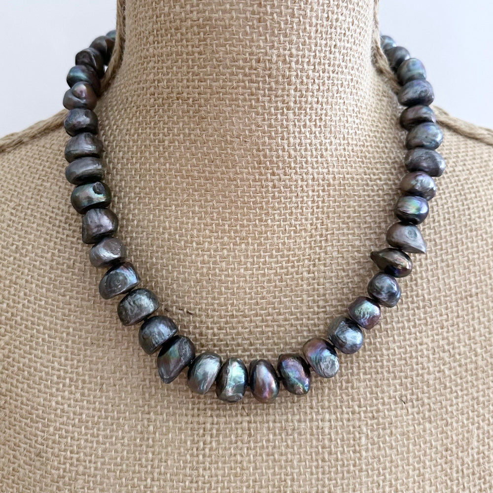 
                      
                        Large Black Baroque Freshwater Pearls Knotted on 18.5” Necklace with 2” Extender.  A Lobster Claw Clasp Completes this Lustrous Piece. Shown on Bust
                      
                    