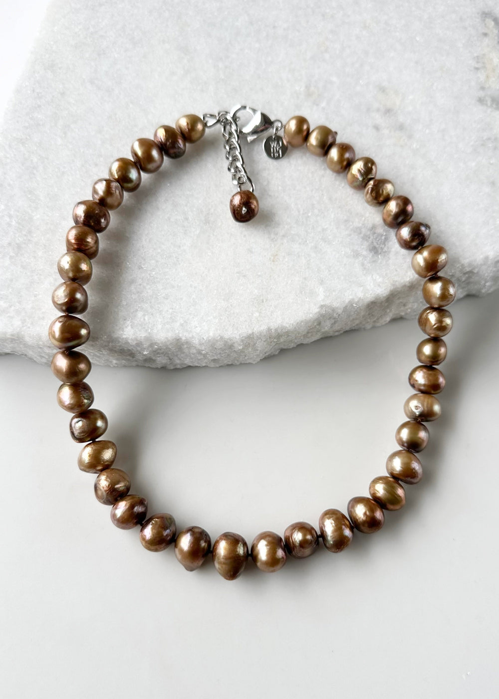 Large Brown Baroque Freshwater Pearls Knotted on 18.5” Necklace with 2” Extender.  A Lobster Claw Clasp Completes this Lustrous Piece.