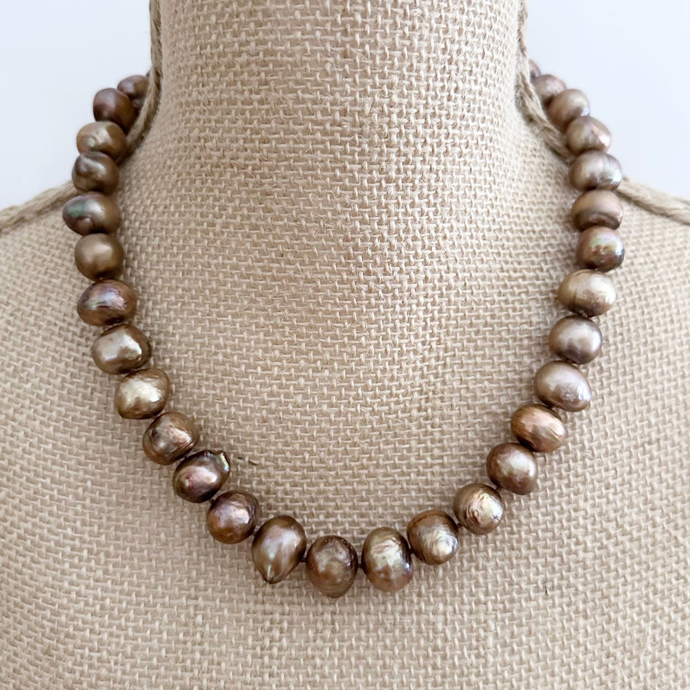 
                      
                        Large Brown Baroque Freshwater Pearls Knotted on 18.5” Necklace with 2” Extender.  A Lobster Claw Clasp Completes this Lustrous Piece.
                      
                    