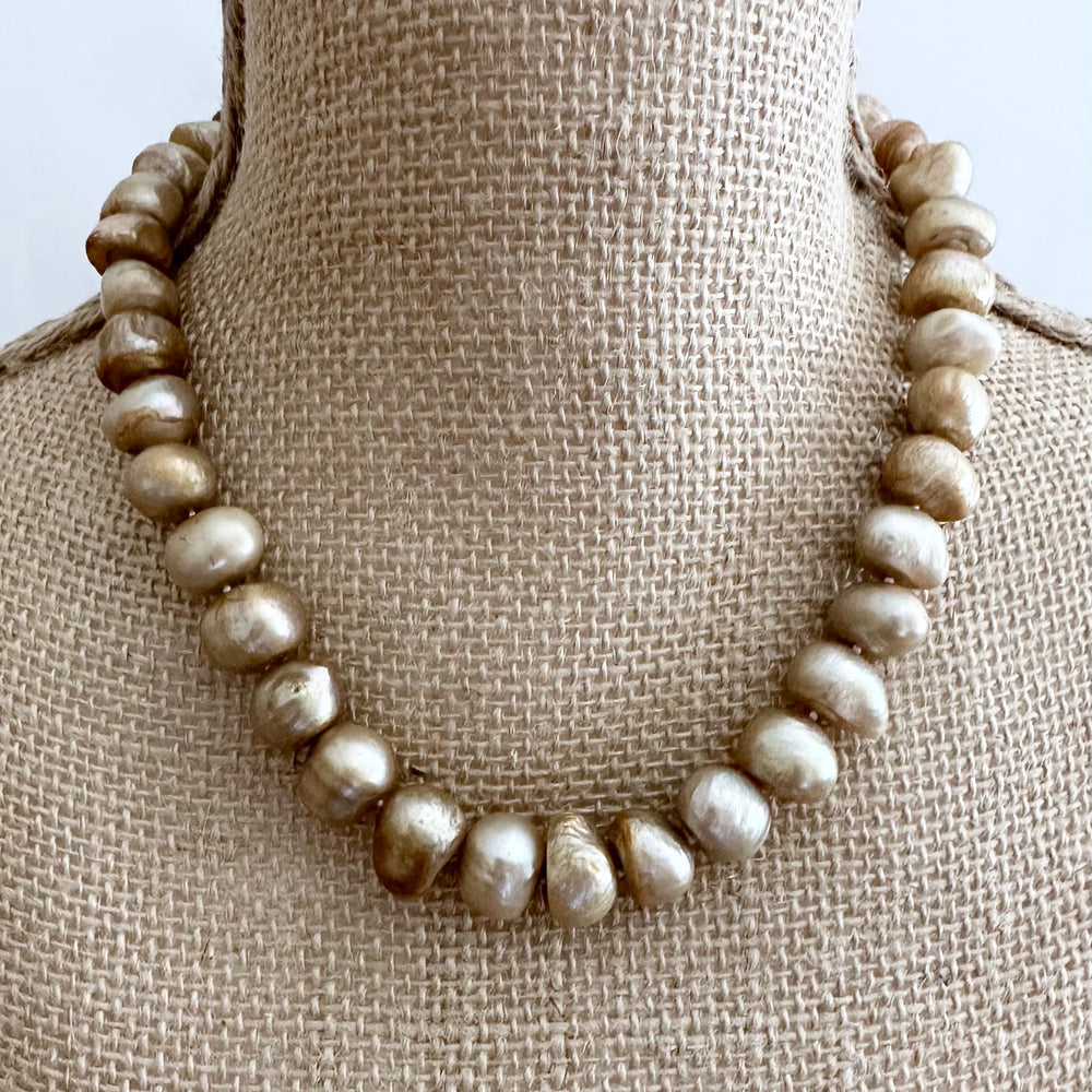
                      
                        Large Gold Baroque Freshwater Pearls Knotted on 18.5” Necklace with 2” Extender.  A Lobster Claw Clasp Completes this Lustrous Piece. Shown on Bust
                      
                    