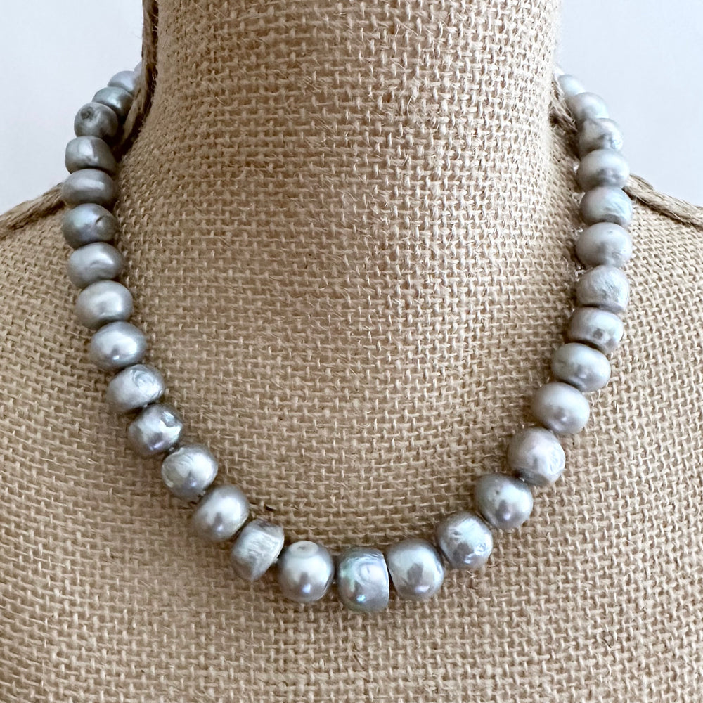 
                      
                        Large Silver Baroque Freshwater Pearls Knotted on 18.5” Necklace with 2” Extender.  A Lobster Claw Clasp Completes this Lustrous Piece. Shown on Bust
                      
                    