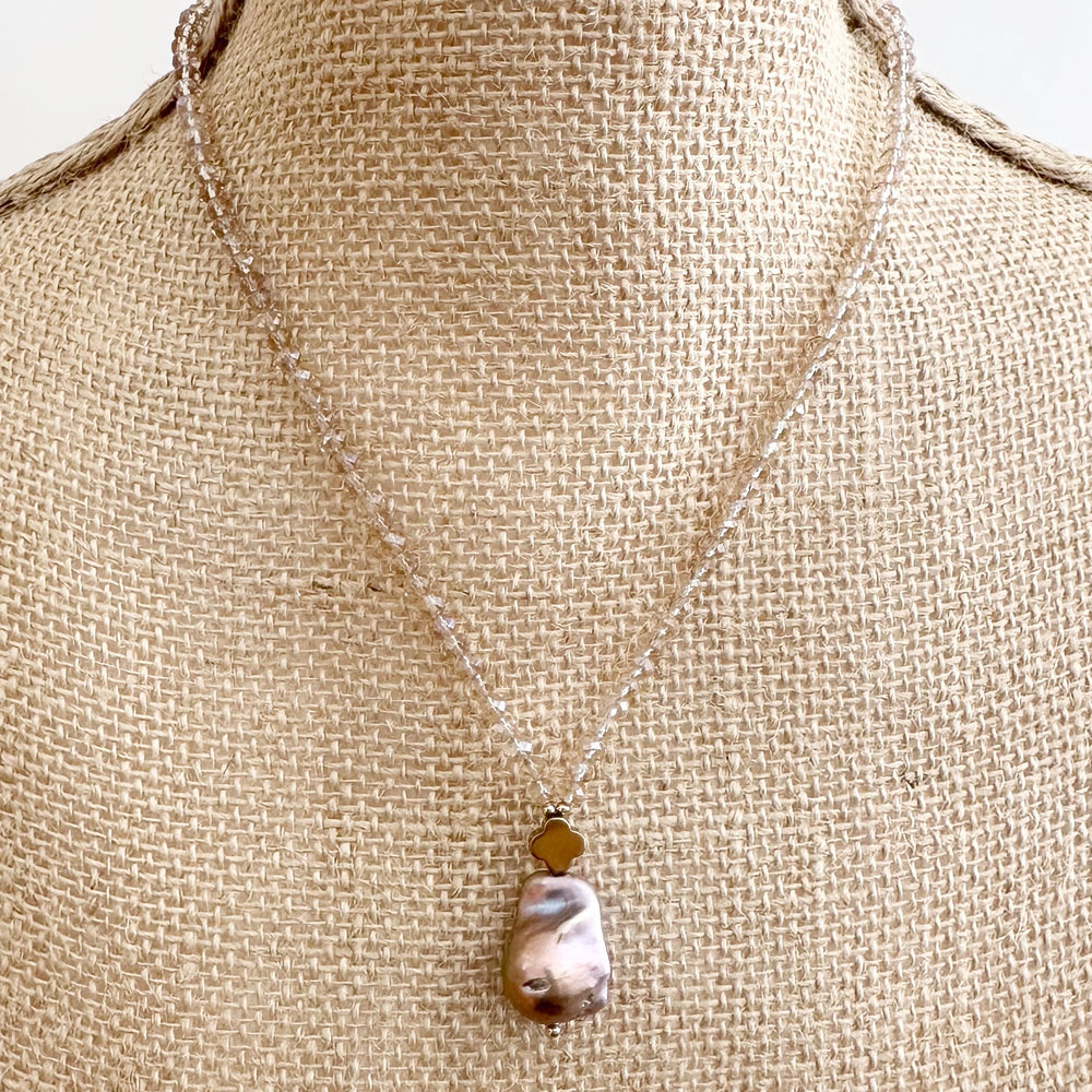 
                      
                        Faceted Champagne Crystals form this Necklace with a Large Baroque Freshwater Pearl Pendant Completed with Gold accents and a Strong Secure Magnetic Clasp for East Wear. On Bust
                      
                    