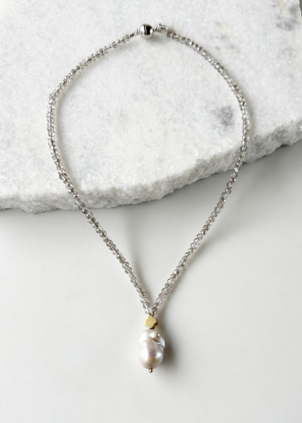 Faceted Smoke Crystals form this Necklace with a Large White Baroque Freshwater Pearl Pendant Completed with Gold accents and a Strong Secure Magnetic Clasp for East Wear.