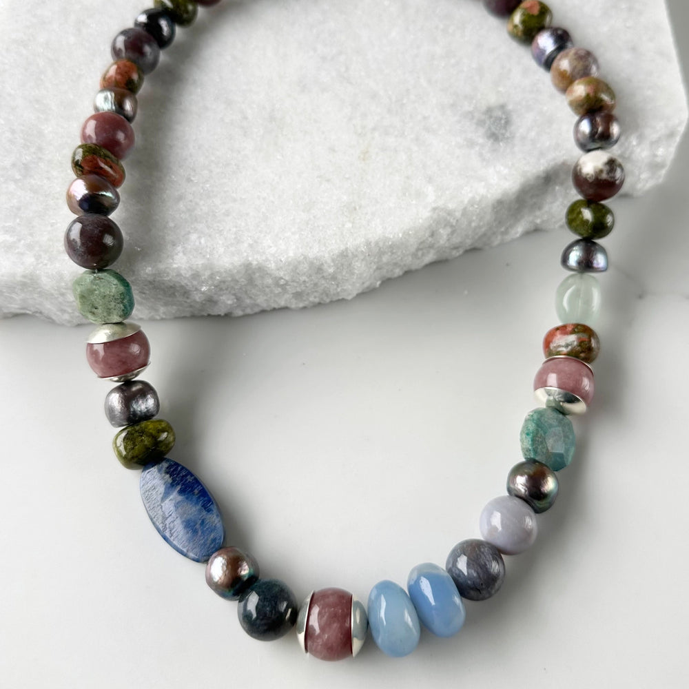 This Exceptional 22.5" Necklace Features a Blend of Jasper, Morango Quartz, Unakite, Fluorite, Dumortierite, Chrysocolla, Pearls, and Silver, with a Sterling silver hook clasp creating a truly one-of-a-kind statement piece. Designed and made in Canada