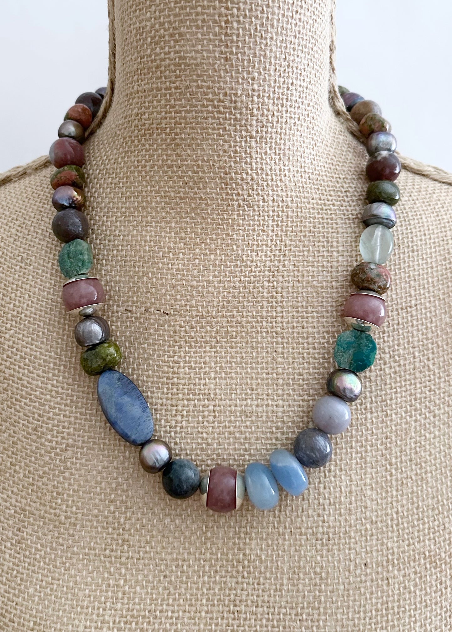 This Exceptional 22.5" Necklace Features a Blend of Jasper, Morango Quartz, Unakite, Fluorite, Dumortierite, Chrysocolla, Pearls, and Silver, with a Sterling silver hook clasp creating a truly one-of-a-kind statement piece. Designed and made in Canada