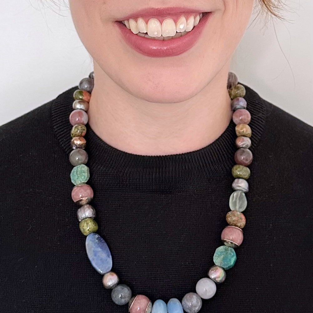 
                      
                        This Exceptional 22.5" Necklace Features a Blend of Jasper, Morango Quartz, Unakite, Fluorite, Dumortierite, Chrysocolla, Pearls, and Silver, with a Sterling silver hook clasp creating a truly one-of-a-kind statement piece. Designed and made in Canada
                      
                    