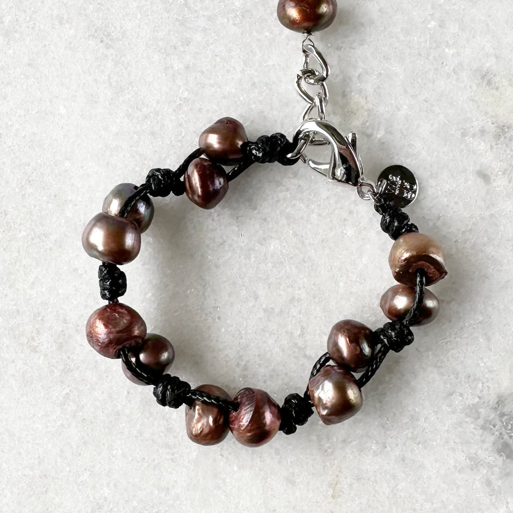 This 7.5” Bracelet Features Lustrous Freshwater Pearls Knotted on Cotton Cord,  Completed with a Large Lobster Claw Clasp and Extender Chain. Designed in Canada.