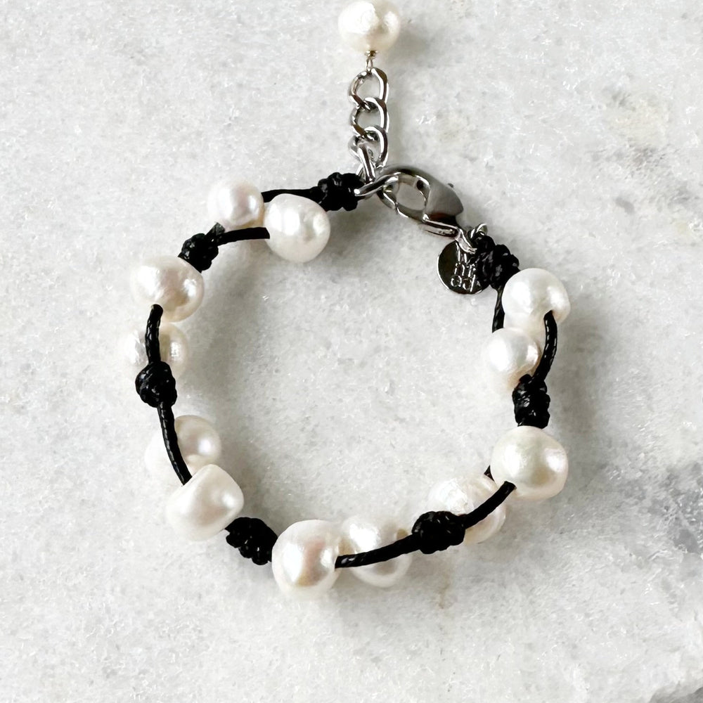 This 7.5” Bracelet Features Lustrous Freshwater Pearls Knotted on Cotton Cord,  Completed with a Large Lobster Claw Clasp and Extender Chain. Designed in Canada.