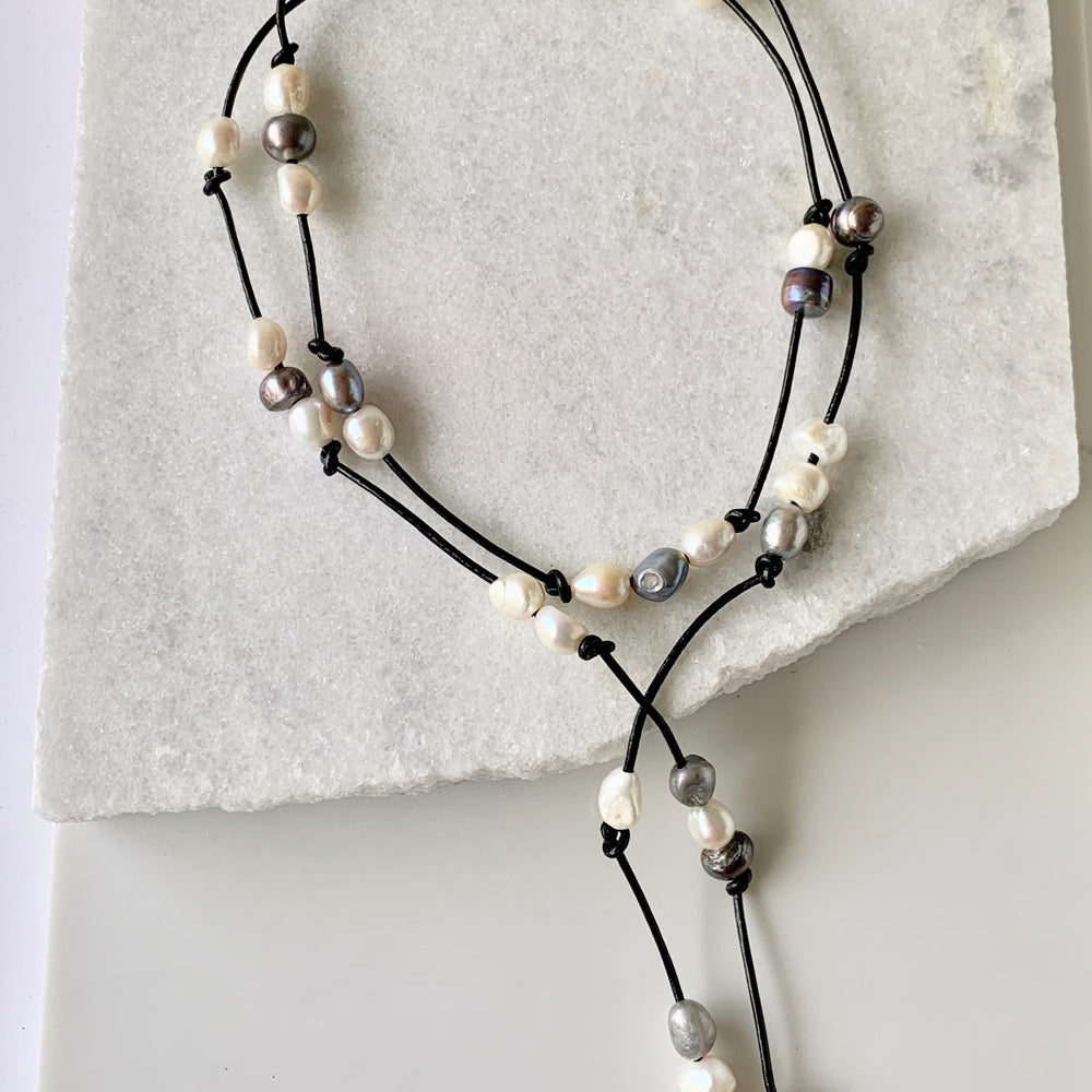 
                      
                        Long 46” Black Leather Lariat Adorned with Lustrous Mixed Freshwater Pearls.  Can be worn Long, Doubled and in a Variety of Ways to Suit your Personal Taste and Mood.
                      
                    