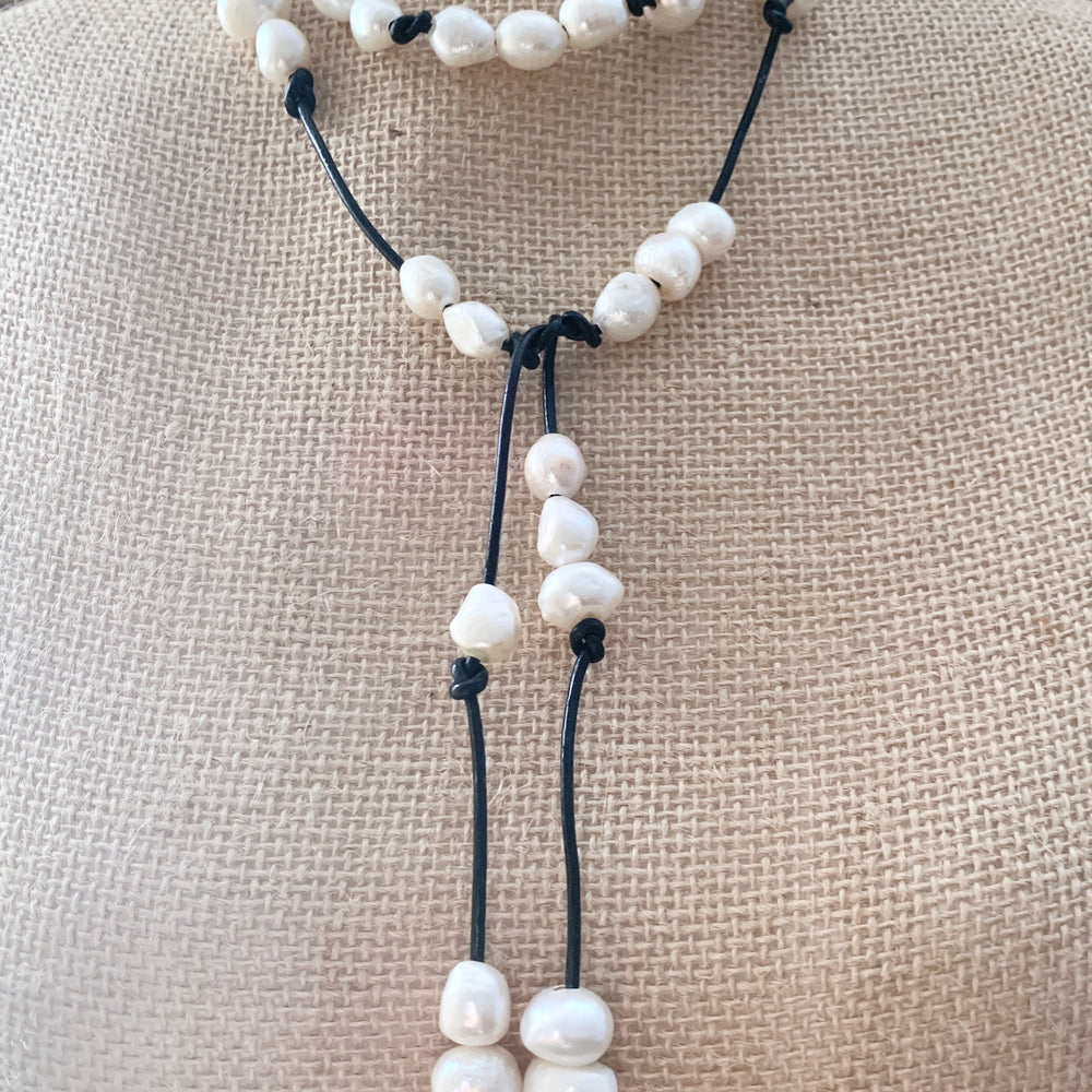 
                      
                        Long 46” Black Leather Lariat Adorned with Lustrous White Freshwater Pearls.  Can be worn Long, Doubled and in a Variety of Ways to Suit your Personal Taste and Mood. ne Creative way to Wear, on Bust
                      
                    