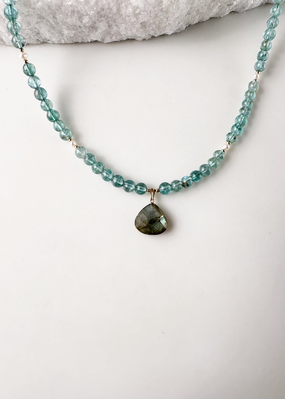Designed and made in Canada, this one-of-a-kind 18.5” Necklace features beautiful Gemmy Apatite (AA grade) in a blue/green shade, with a Labradorite Pendant and tiny Pearls accented with Gold beads and finished with a Gold-filled lobster claw clasp