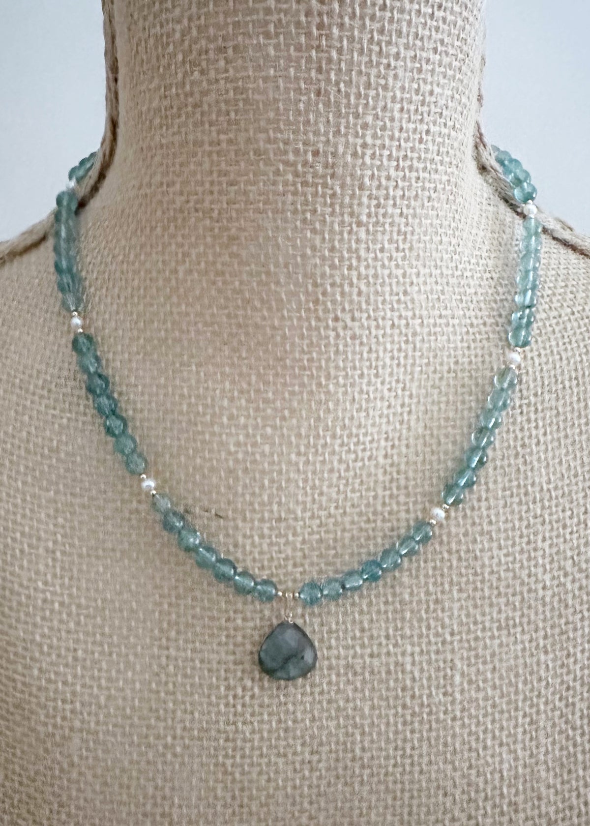 Designed and made in Canada, this one-of-a-kind 18.5” Necklace features beautiful Gemmy Apatite (AA grade) in a blue/green shade, with a Labradorite Pendant and tiny Pearls accented with Gold beads and finished with a Gold-filled lobster claw clasp