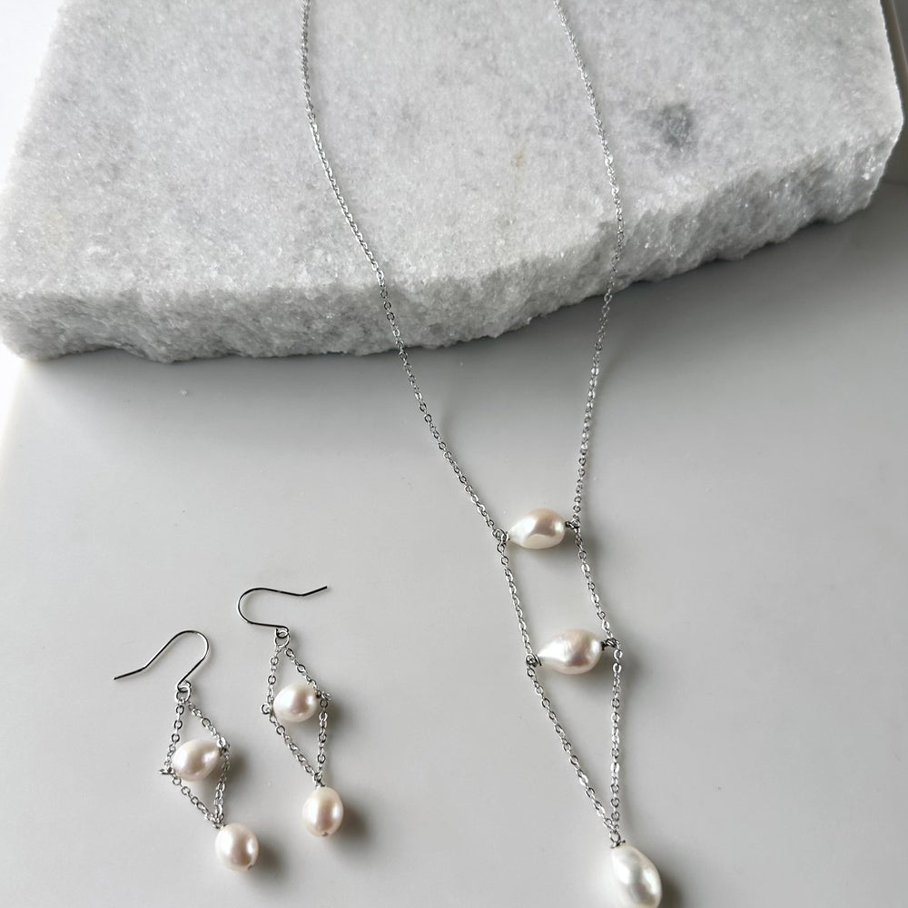 
                      
                        Delicate and Light Silver Chain and Freshwater Pearl Earrings on Sterling Silver Hooks. With Matching Necklace
                      
                    