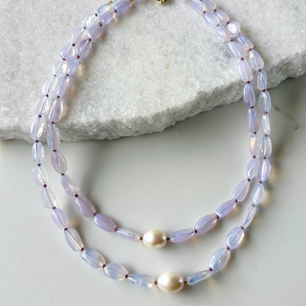 
                      
                        Pretty Limited Edition 20.5" Necklace with Beautiful Lavender Amethyst (Soft Milky Finish) and a Large White Freshwater Pearl with Gold Accents.  Designed and Made in Canada, this piece is Finished with a Gold-Filled Lobster Claw Clasp.
                      
                    