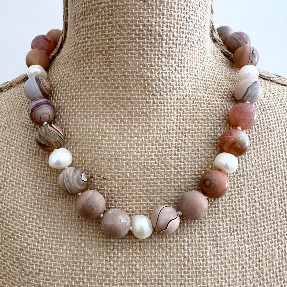 This 19.5” Necklace Highlights Large (16mm) Round Agate with Shades of Peach, Grey and Mauve with White Pearls. It fastens Effortlessly with a Convenient Magnetic Clasp, combining style and ease. Designed in Canada
