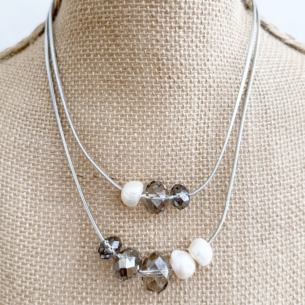 
                      
                        Large Baroque Freshwater White Pearls and Large Silver Crystals on Two Strands of Silver Metallic Cord, Finished by a Strong Secure Magnetic Clasp for Easy Wear.
                      
                    