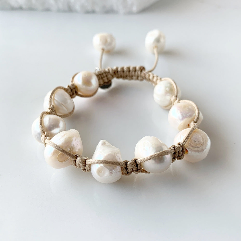 Nine Large White Baroque Freshwater Pearls on Beige Knotted Cord Plus Sliding Knot Closure with Two Smaller Pearls to Offer Adjustable Length.