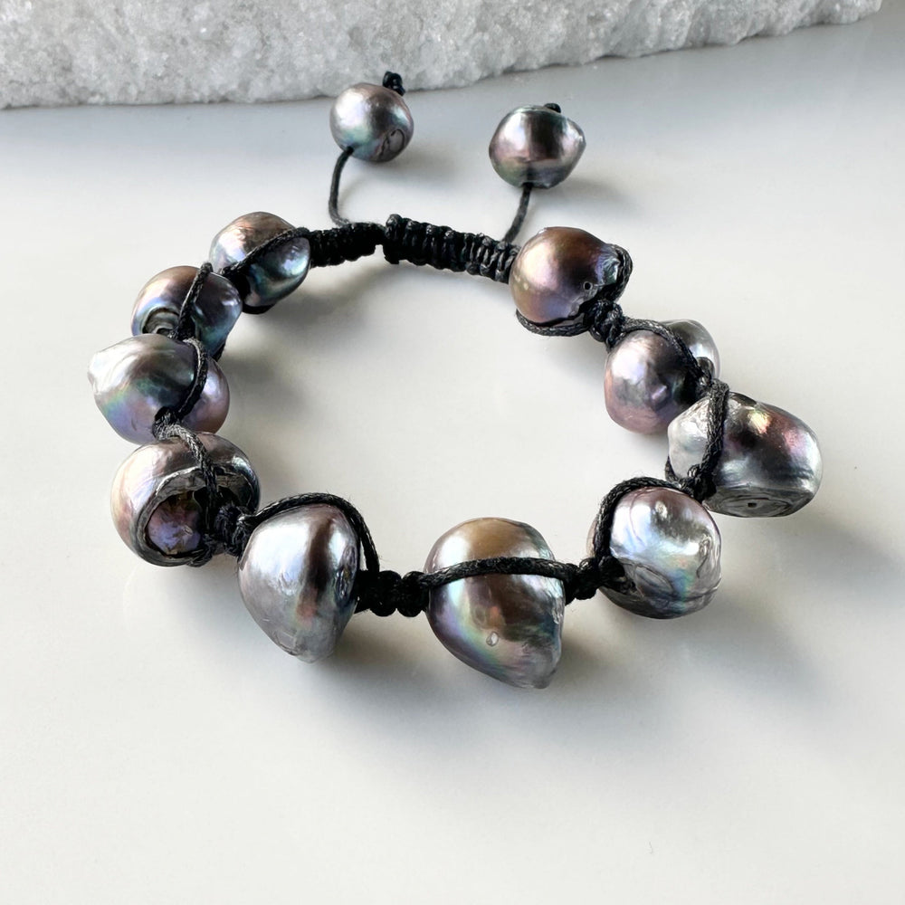 
                      
                        Nine Large Black Baroque Freshwater Pearls on Black Knotted Cord Plus Sliding Knot Closure with Two Smaller Pearls to Offer Adjustable Length.
                      
                    