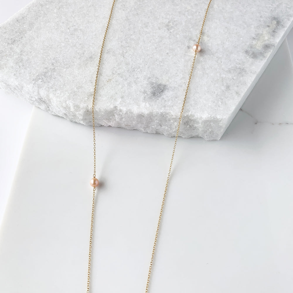
                      
                        This One-Of-A-Kind Necklace Features Three Ocean Jasper Stones on a Gold-Filled Chain with 15” Drop and Two Beautiful Peach Colored Freshwater Pearls.
                      
                    