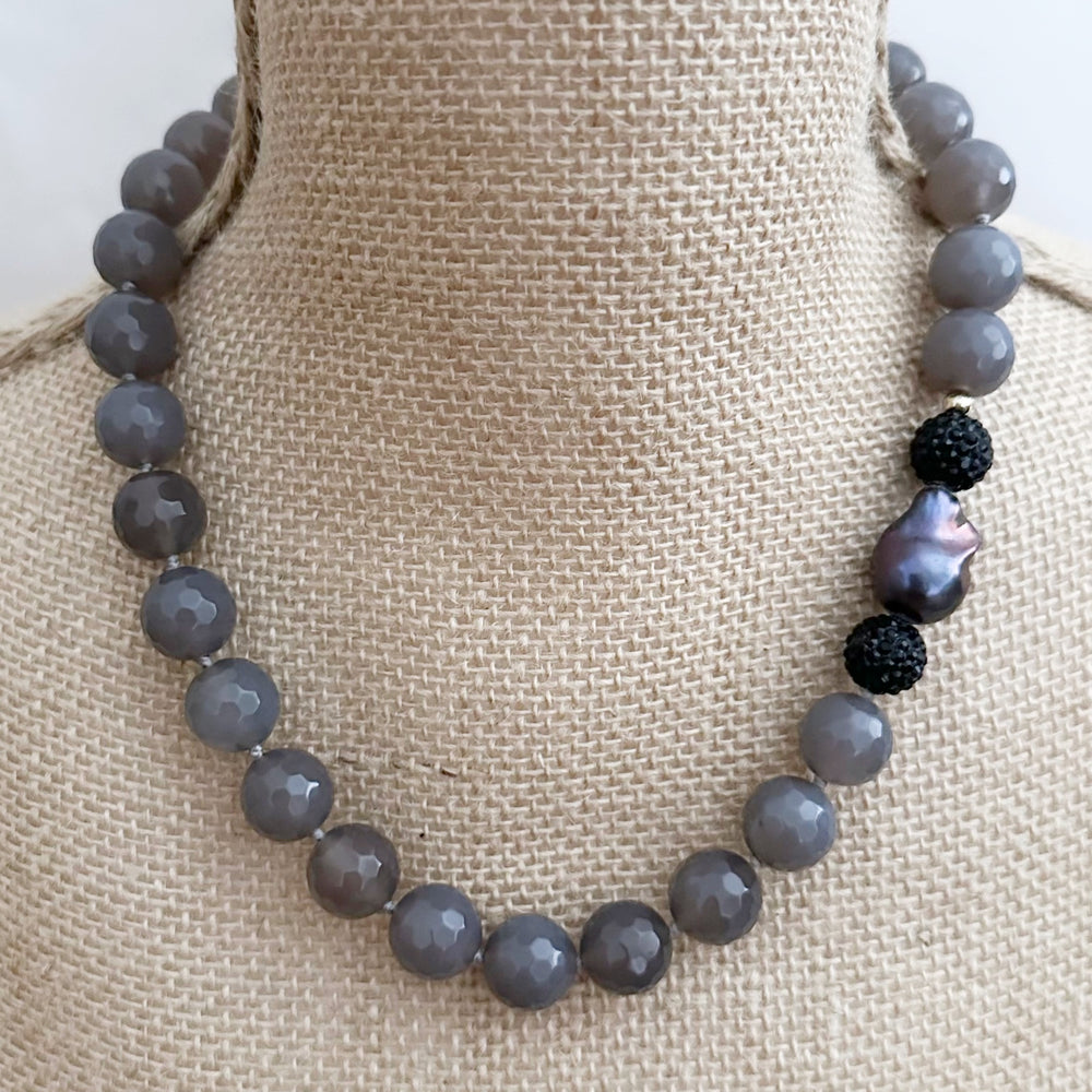 
                      
                        Large Faceted Agate with Large Black Baroque Freshwater Pearl Accented by Crystal Beads on a 20” Necklace with Strong Secure Magnetic Clasp for Easy Wear. On Bust
                      
                    