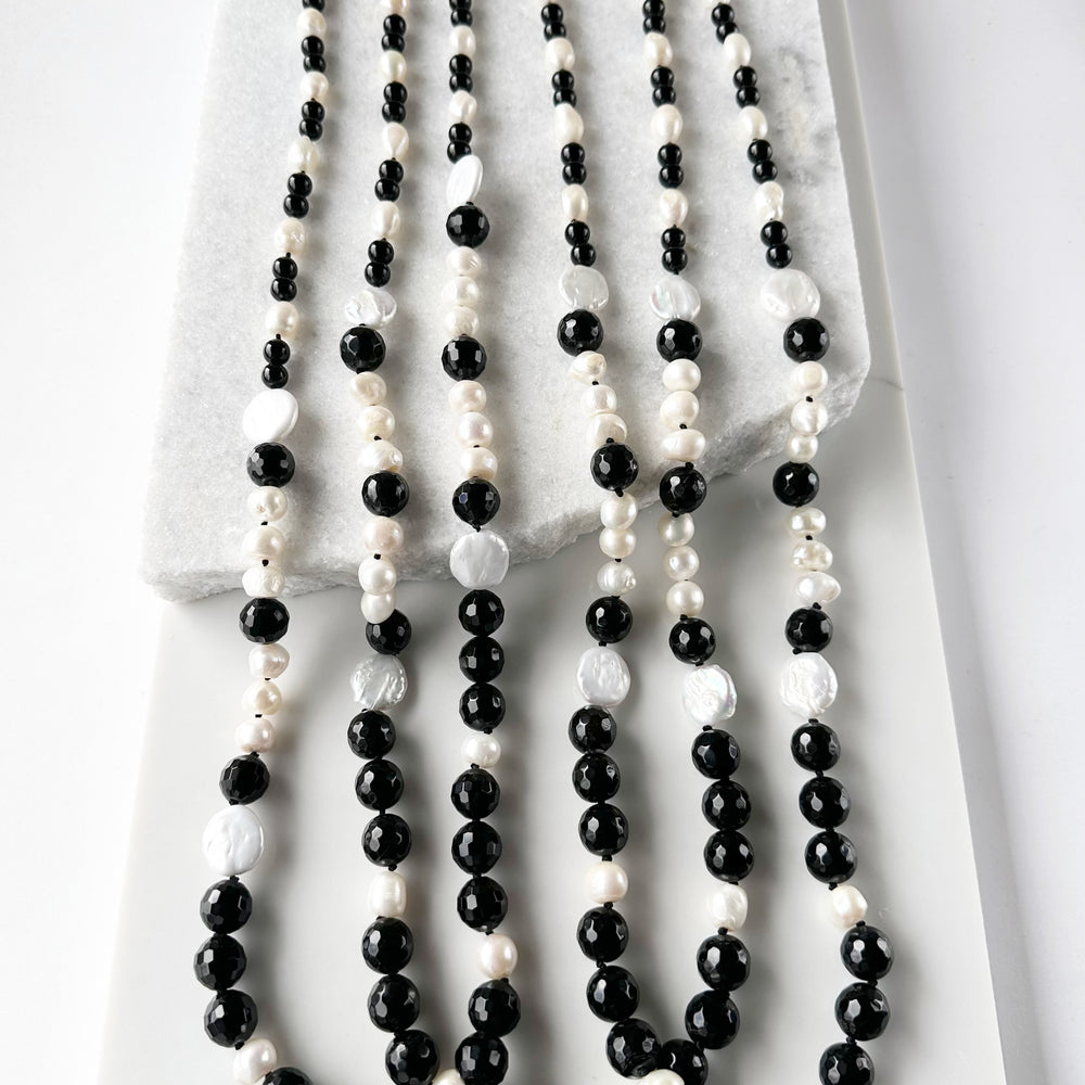 
                      
                        Large White Baroque and Coin Freshwater Pearls Adorn this Necklace with 8-14mm Faceted Black Agate. Three Shown
                      
                    