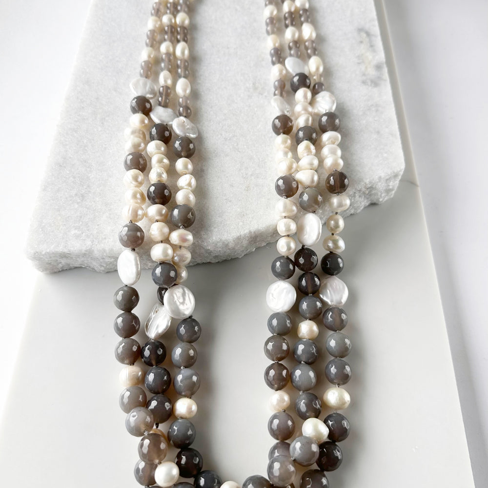 
                      
                        Large White Baroque and Coin Freshwater Pearls Adorn this Necklace with 8-14mm Faceted Grey Agate. Three Shown
                      
                    