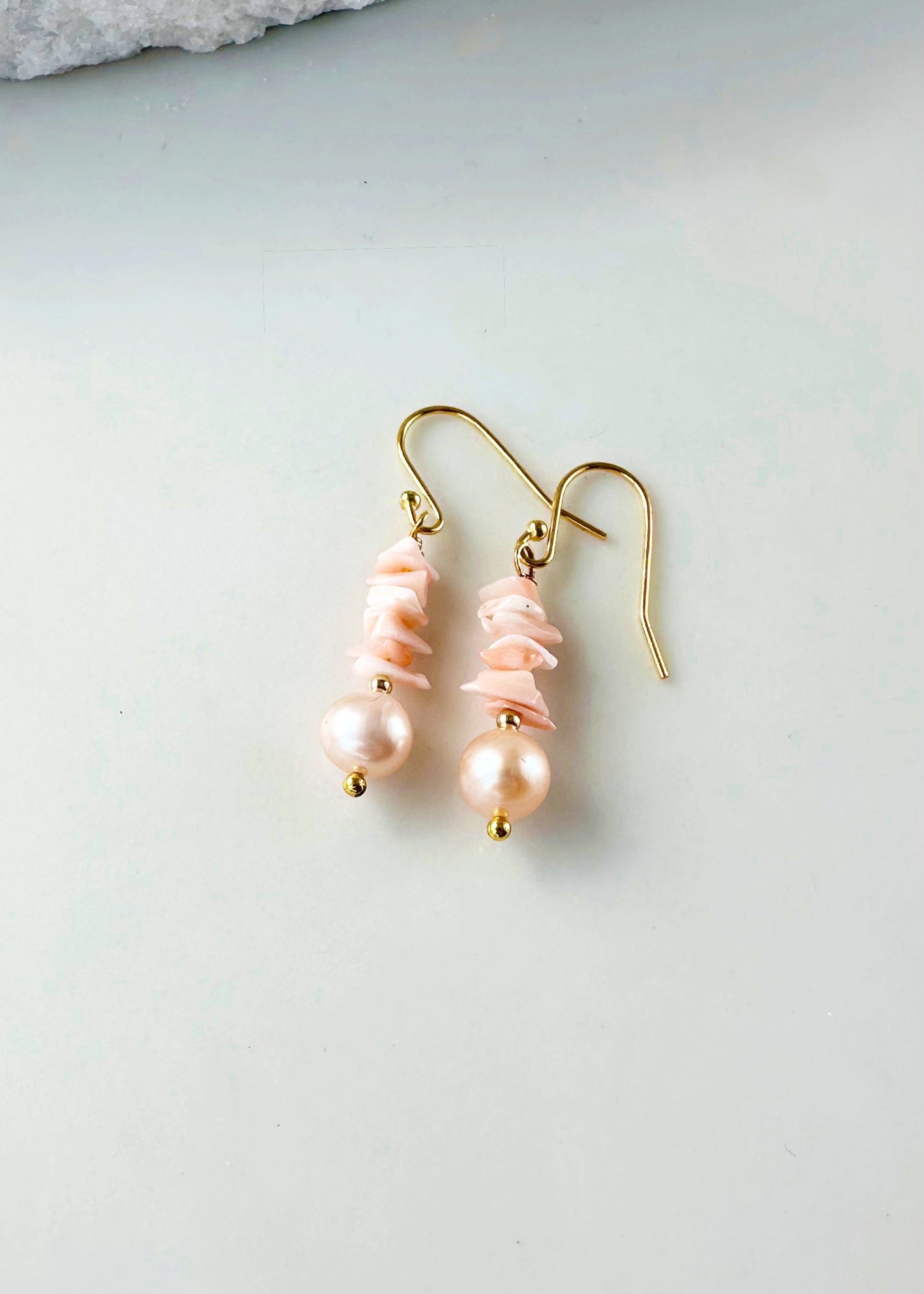 Designed and made in Canada, this 1.5” Earring features Pretty Coral with Lustrous Peach Pearls highlighted with gold beads and Gold-plated hooks.