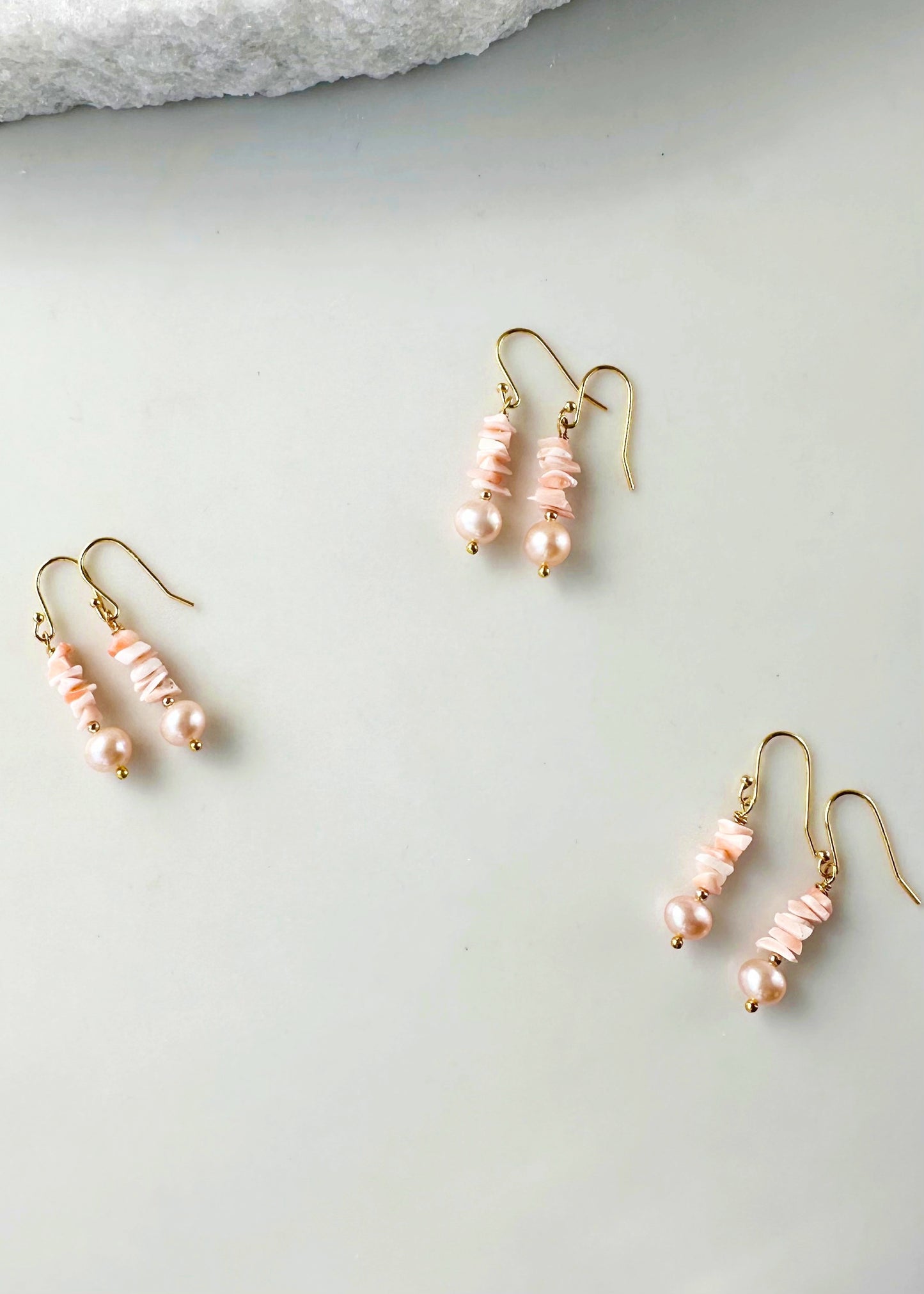 Designed and made in Canada, this 1.5” Earring features Pretty Coral with Lustrous Peach Pearls highlighted with gold beads and Gold-plated hooks.