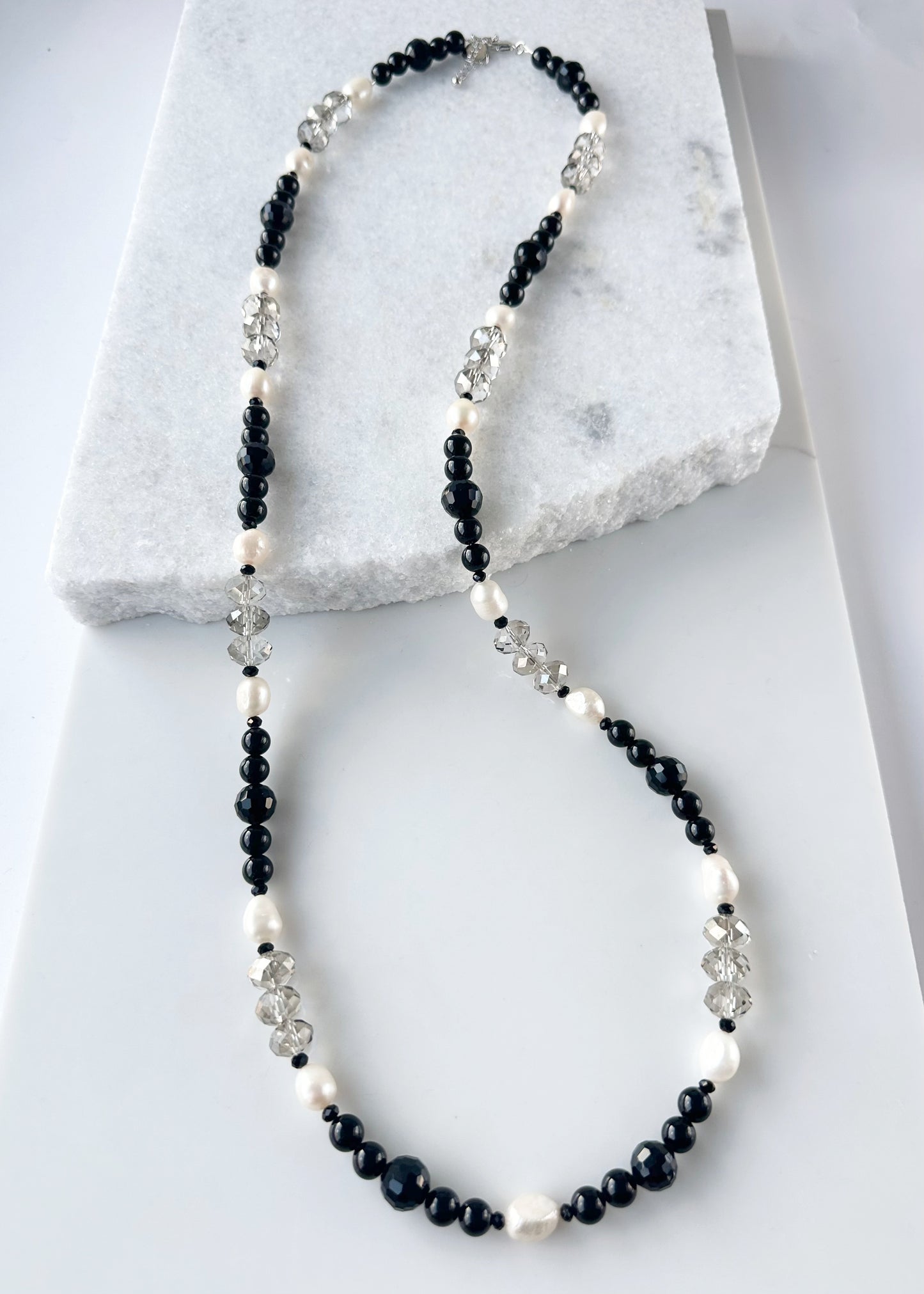 This One Of A Kind, Distinctive 38” Necklace (with 1.5” Extender) has Lustrous White Freshwater Pearls, Smoky Faceted Crystals and deep Black Agate. Designed and made in Canada and Completed with a Lobster Claw Clasp, Style it Draped Long or Doubled for Layered Impact.