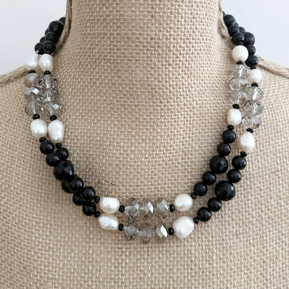 
                      
                        This One Of A Kind, Distinctive 38” Necklace (with 1.5” Extender) has Lustrous White Freshwater Pearls, Smoky Faceted Crystals and deep Black Agate. Designed and made in Canada and Completed with a Lobster Claw Clasp, Style it Draped Long or Doubled for Layered Impact.
                      
                    