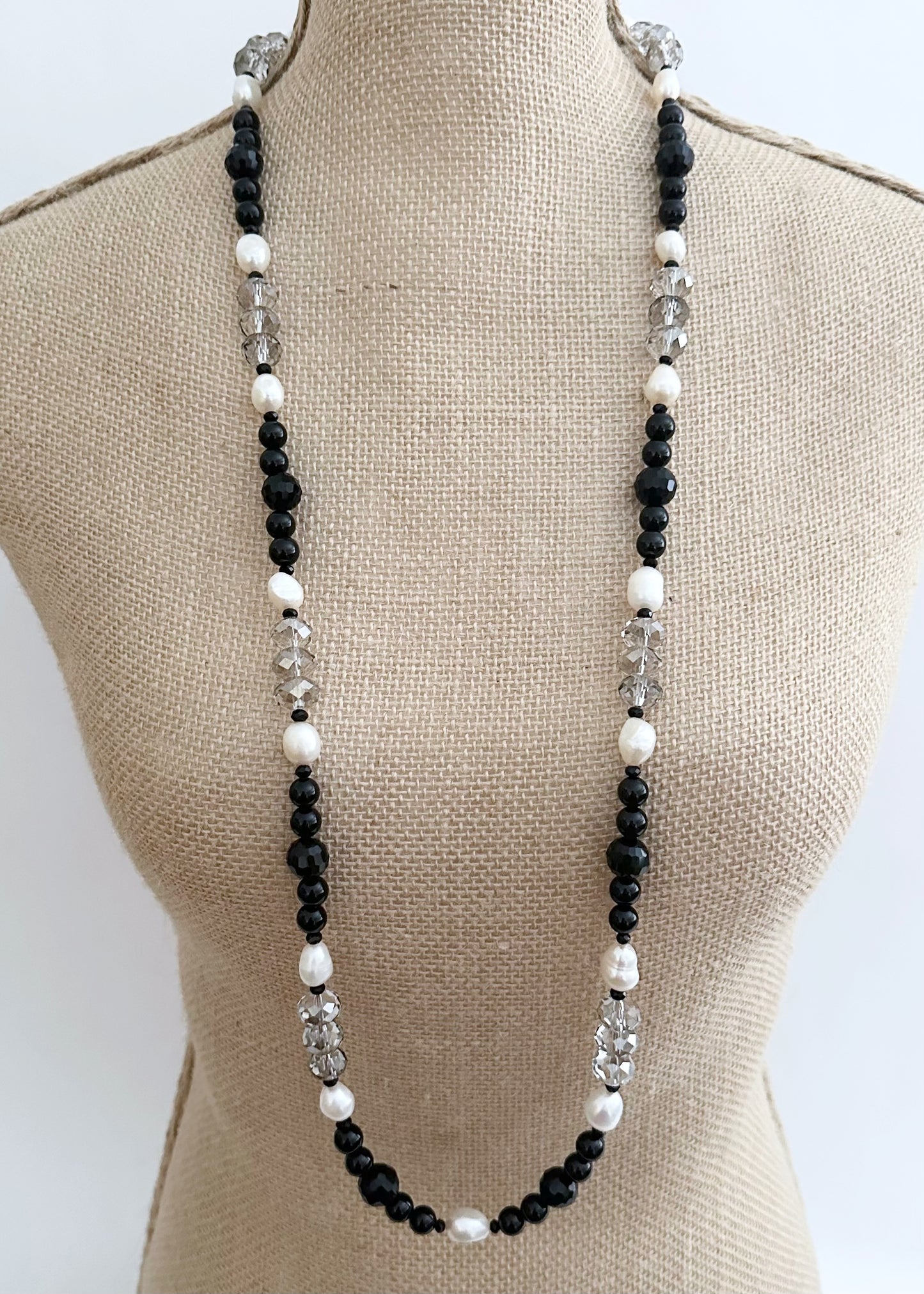 This One Of A Kind, Distinctive 38” Necklace (with 1.5” Extender) has Lustrous White Freshwater Pearls, Smoky Faceted Crystals and deep Black Agate. Designed and made in Canada and Completed with a Lobster Claw Clasp, Style it Draped Long or Doubled for Layered Impact.