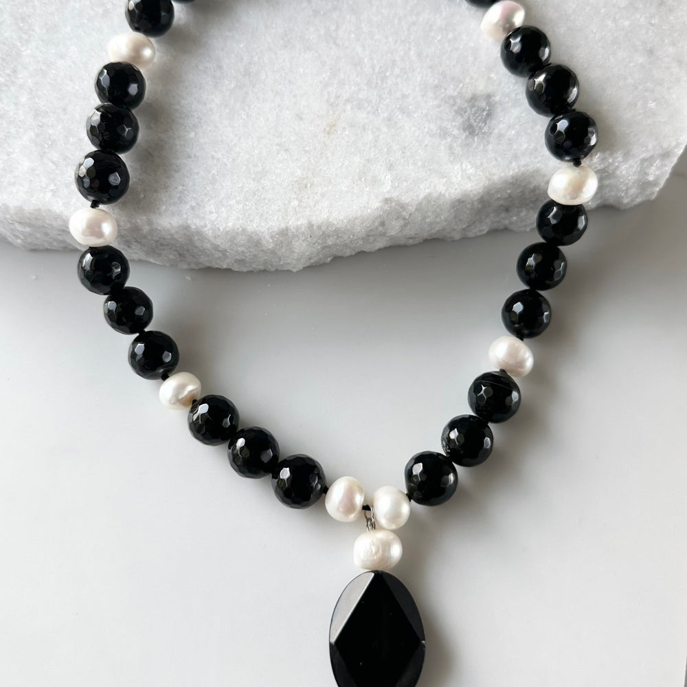 
                      
                        Large Freshwater Pearls Adorn this Necklace of Large (14mm) Black Agate with 2” Pendant and a Strong Secure Magnetic Clasp for Easy Wear.
                      
                    