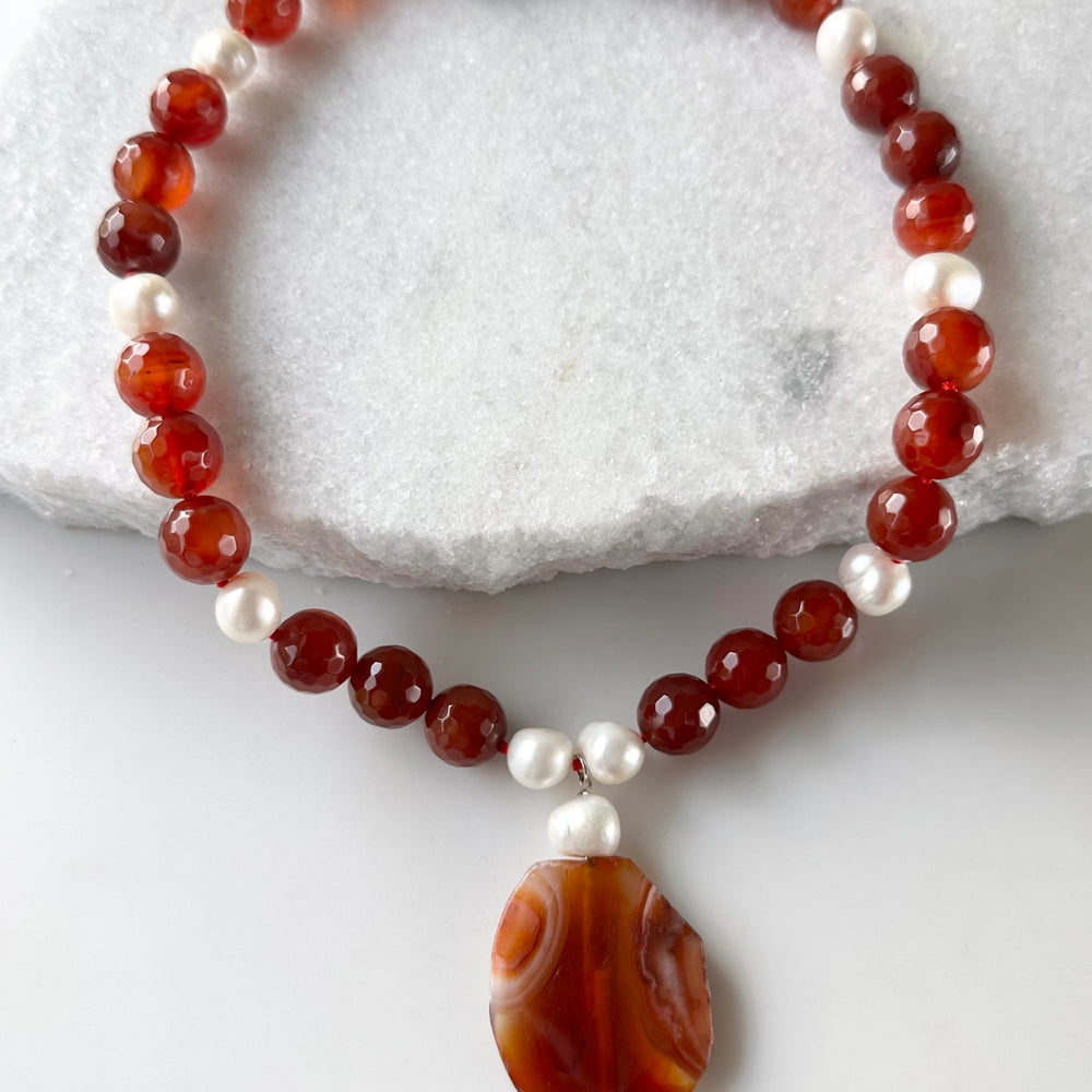 
                      
                        Large Freshwater Pearls Adorn this Necklace of Large (14mm) Carnelian with 2” Pendant and a Strong Secure Magnetic Clasp for Easy Wear.
                      
                    