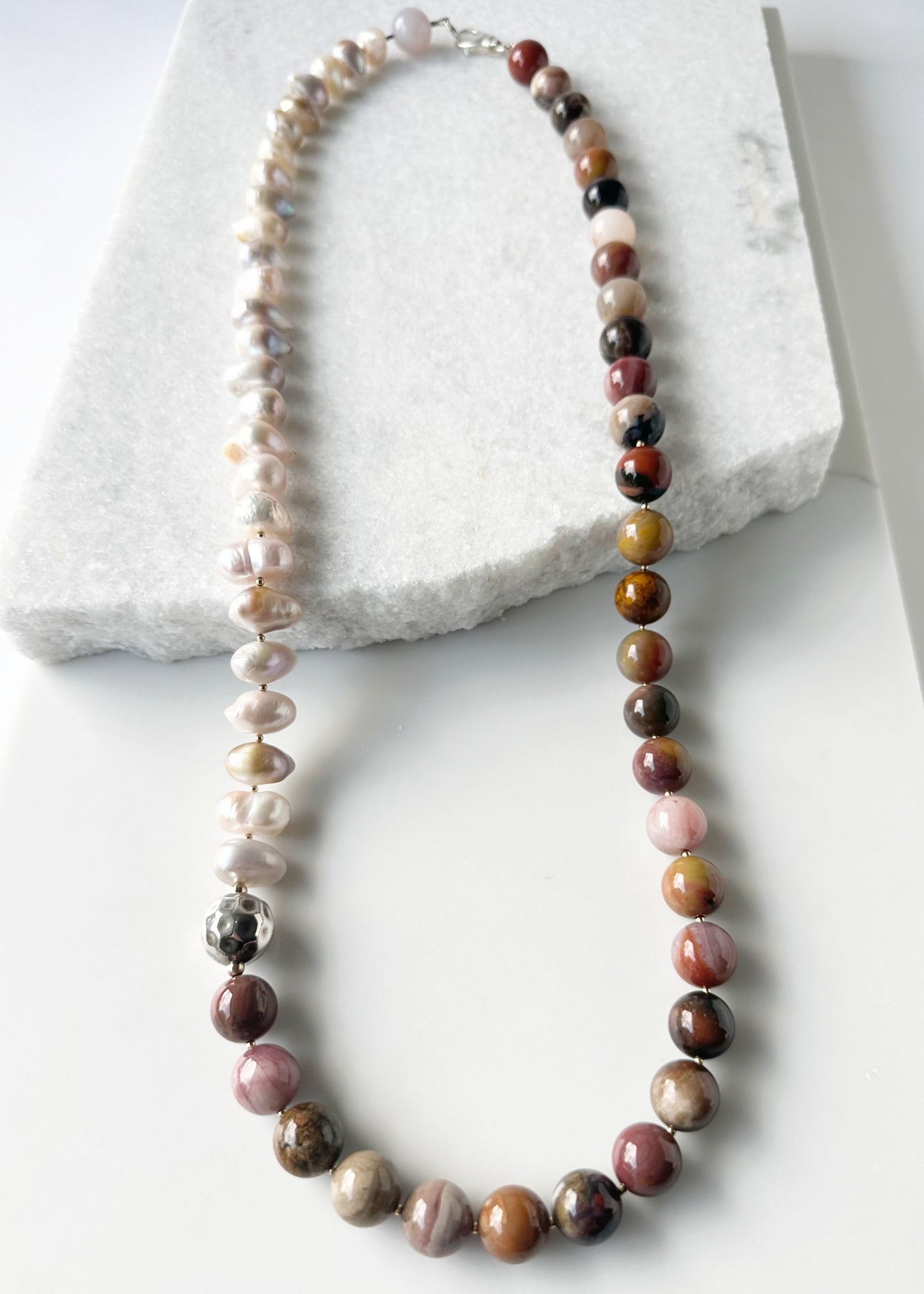 This Stunning, One-Of-A-Kind Piece has Large Baroque Soft Pink Freshwater Pearls with 14mm Petrified Wood in Brown Gold Rust and Pink for a 34” Necklace that is Completed by a Lobster Claw Clasp and Accented by Silver and Gold-Filled Beads.