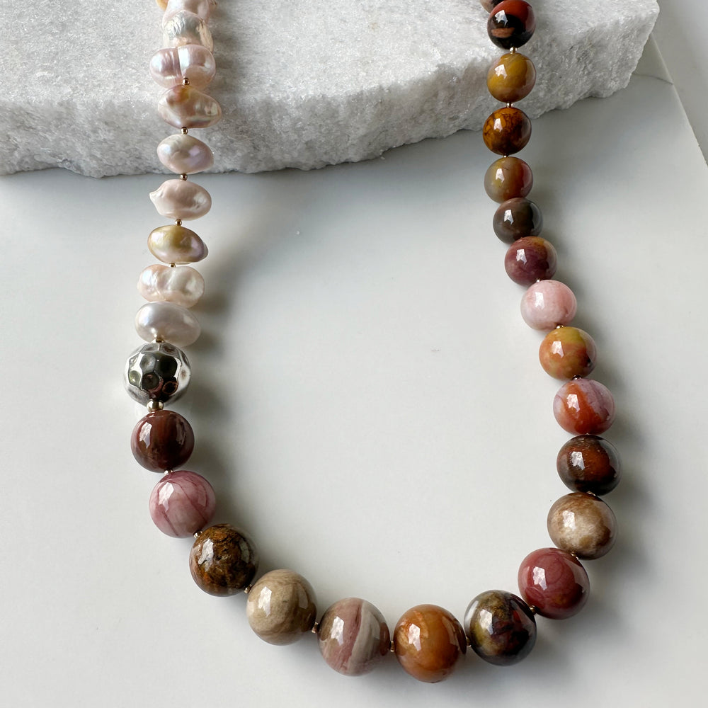 This Stunning, One-Of-A-Kind Piece has Large Baroque Soft Pink Freshwater Pearls with 14mm Petrified Wood in Brown Gold Rust and Pink for a 34” Necklace that is Completed by a Lobster Claw Clasp and Accented by Silver and Gold-Filled Beads. Focus on Petrified Wood Colors and Finish