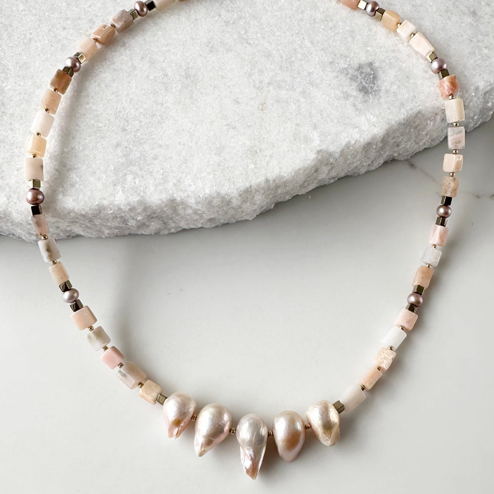 
                      
                        Exquisite 20.5” Necklace with Five Large Pink Baroque Pearls Surrounded by Pink Opal, Accented by Gold-Plated Hematite and Finished with a Gold-Plated Lobster Claw for Secure Wear.
                      
                    
