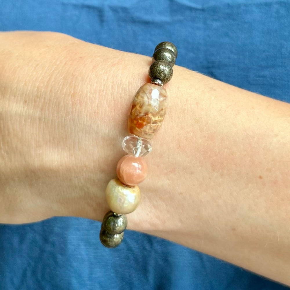 
                      
                        •	Fitting up to a 7” wrist, this Limited Edition Stretch Bracelet Boasts 8mm Pyrite, Freshwater Pearl, Moonstone, Quartz, Agate and Hematite. On Wrist
                      
                    