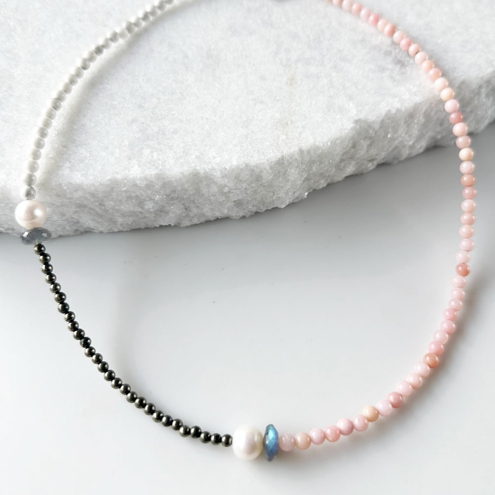 Two Lustrous White Freshwater Pearls Combine with Pink Opal, Pyrite, Howlite and Faceted Labradorite in this 19” One-Of-A-Kind Necklace Completed with Sterling Silver Lobster Claw Clasp.