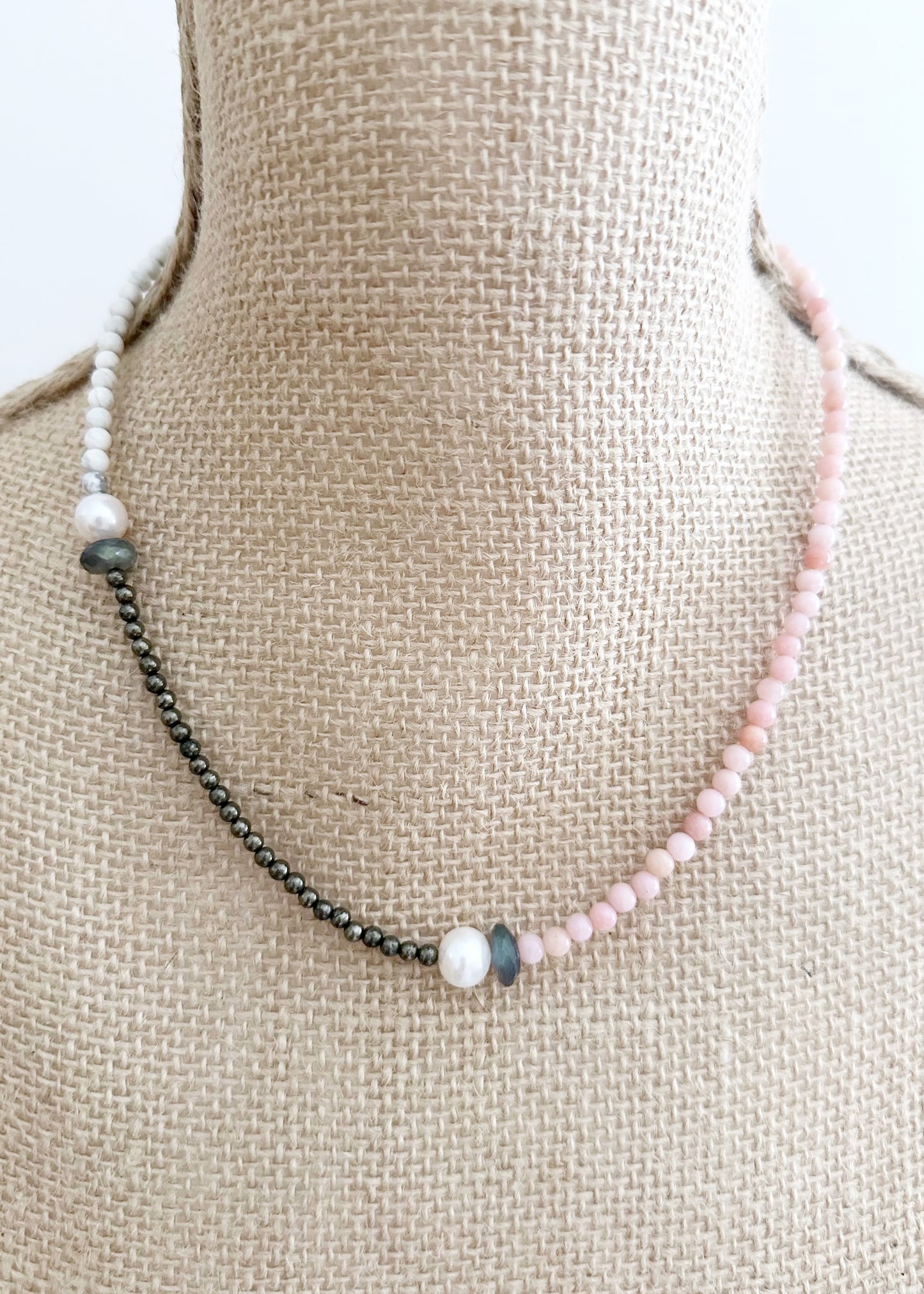 Two Lustrous White Freshwater Pearls Combine with Pink Opal, Pyrite, Howlite and Faceted Labradorite in this 19” One-Of-A-Kind Necklace Completed with Sterling Silver Lobster Claw Clasp. On Bust