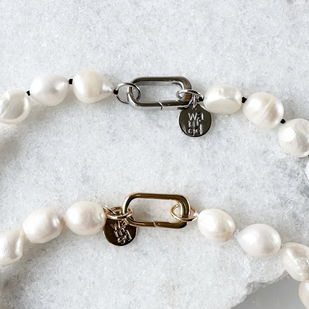 
                      
                        Lustrous Baroque Freshwater Pearls are Knotted in White or Black with a Gold or Silver Charm Clasp to Place your Favorite Pendants.  And Wear the 18.5” Necklace in Reverse to show off the Classic Pearls. Clasps highlighted.
                      
                    