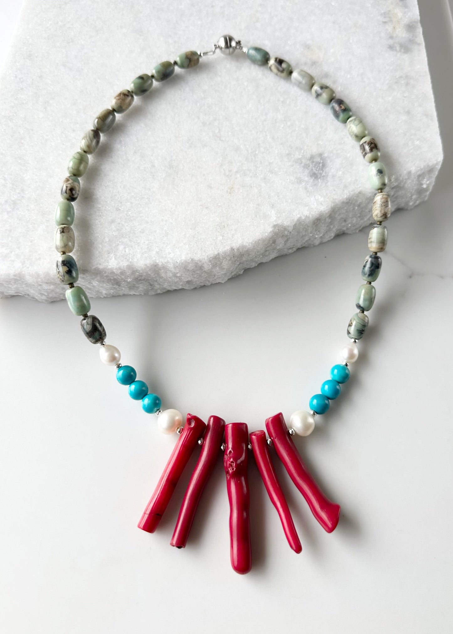 This 21” Statement Necklace Boasts Red Sea Bamboo, Terra Agate, Turquoise and Beautiful White Freshwater Pearls and are finished with Silver Beads and a Magnetic Ball Clasp for Easy Wear.