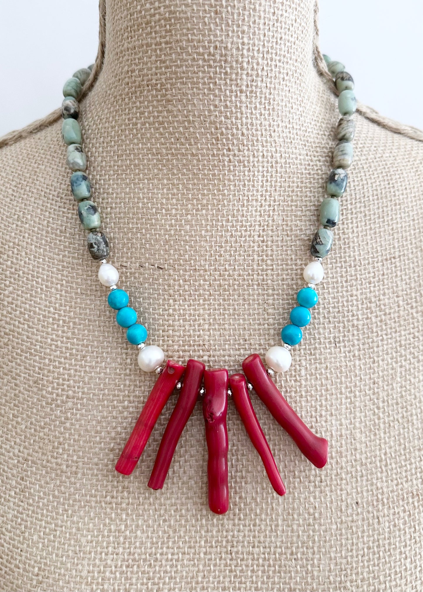 This 21” Statement Necklace Boasts Red Sea Bamboo, Terra Agate, Turquoise and Beautiful White Freshwater Pearls and are finished with Silver Beads and a Magnetic Ball Clasp for Easy Wear.