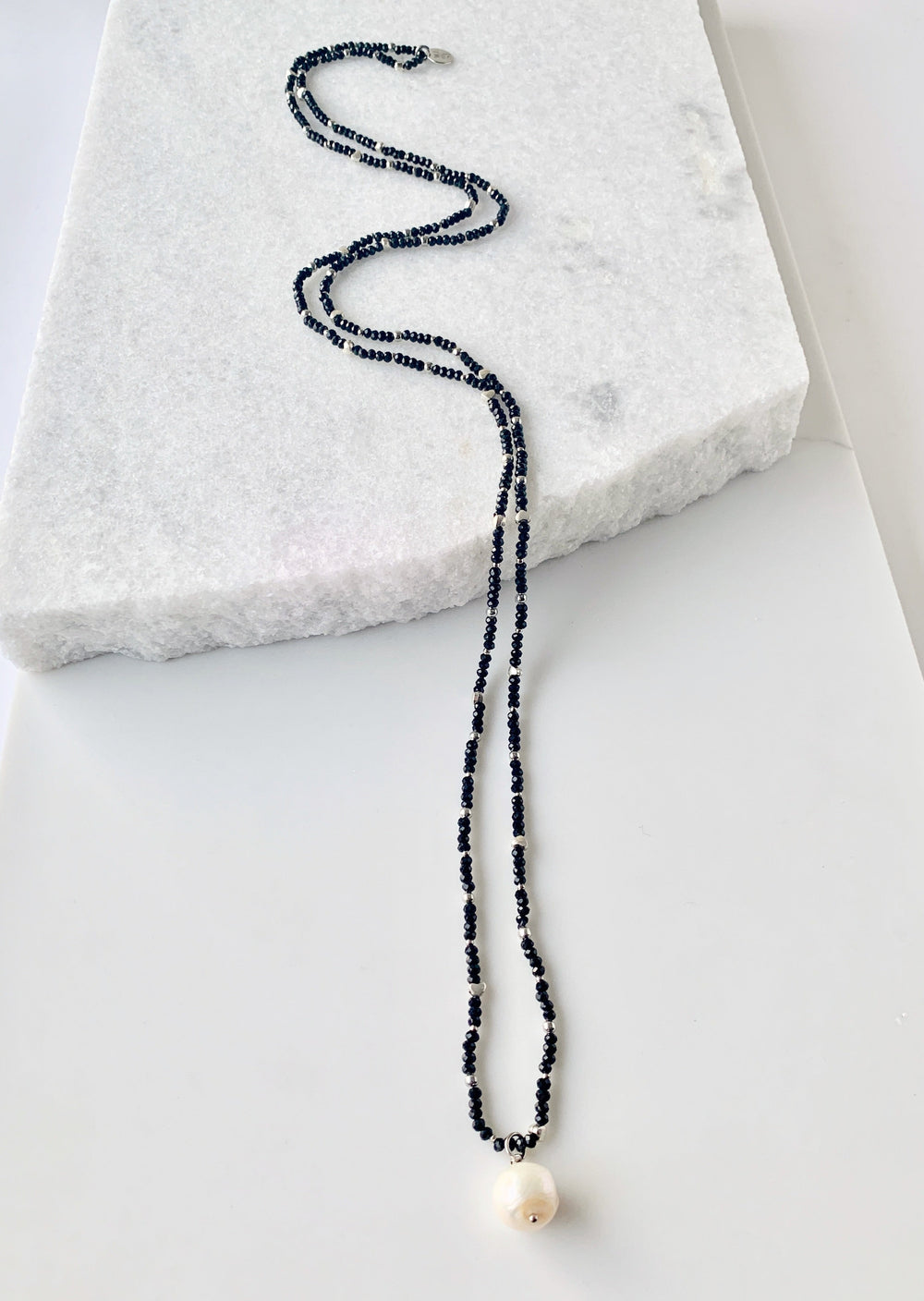 A White Freshwater Pearl Drop falls from this 21” Necklace of Delicate 2mm Black Crystals and Silver Beads with No Clasp.  Great for Layering with Other Favorites.